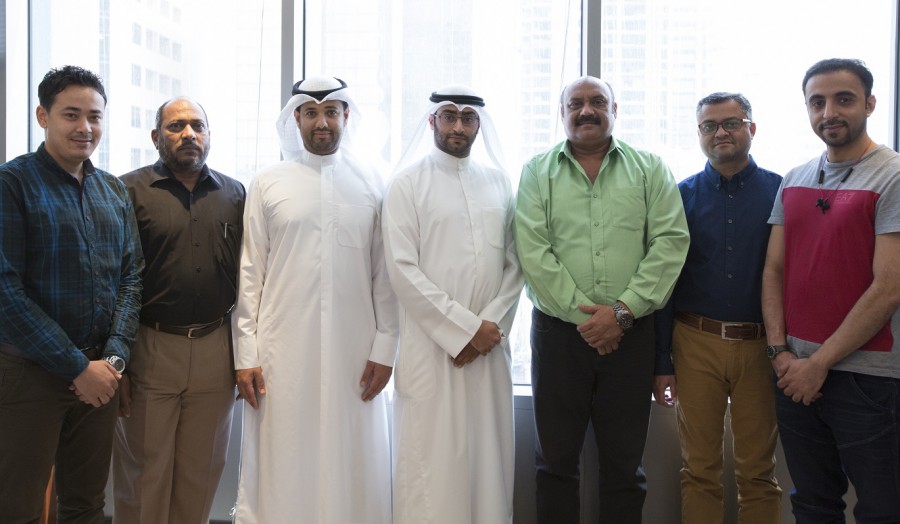 Image of 7 members of the Kuwait team, smiling